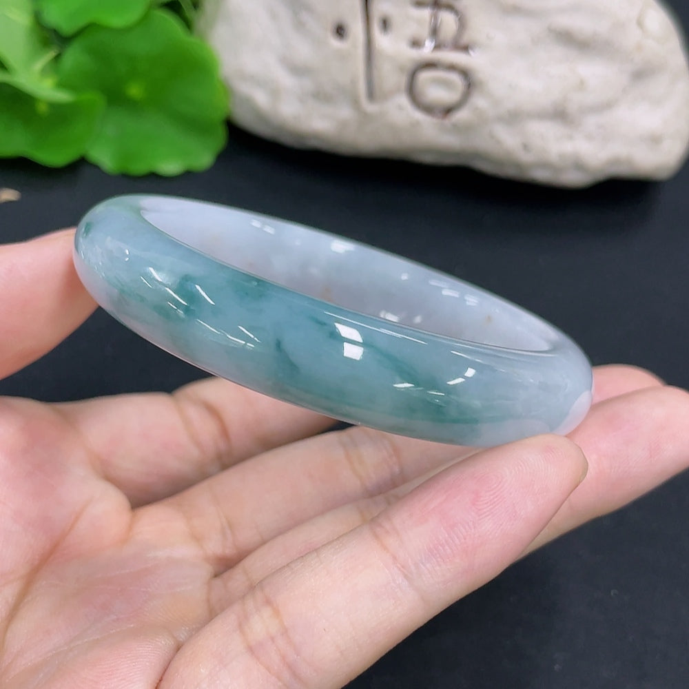 Jadeite round bangle with a polished finish, weighing approximately 49.3g, size 54.4, by HKHQ, showcasing smooth, vibrant jade jewelry.