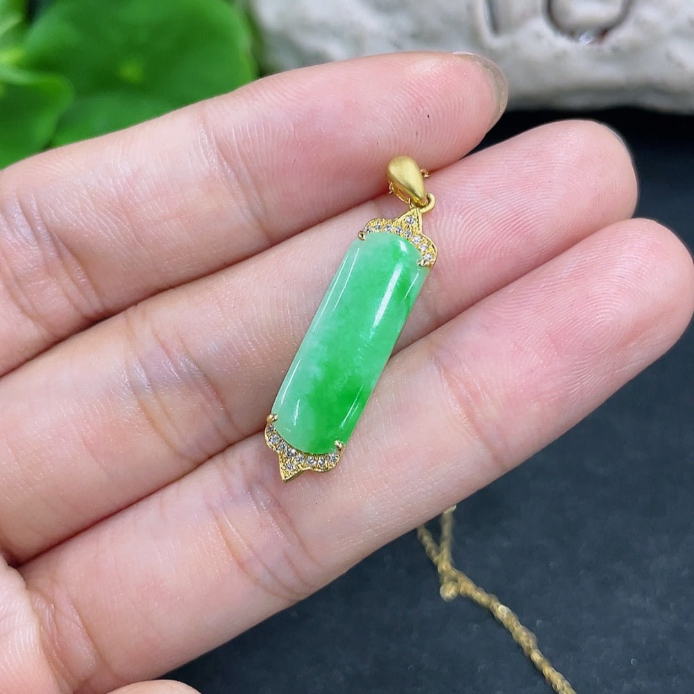 Jadeite pendant with 18K gold and diamond accents, featuring a polished green jade stone, on a delicate chain.