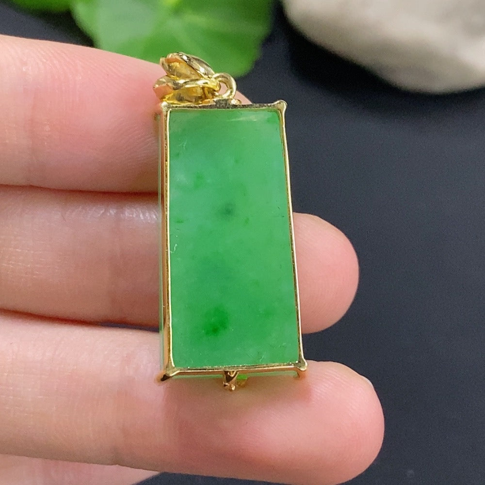 Jadeite inlaid pendant with 18k gold setting, weighing approximately 7.1g, featuring intricate jade jewelry craftsmanship.