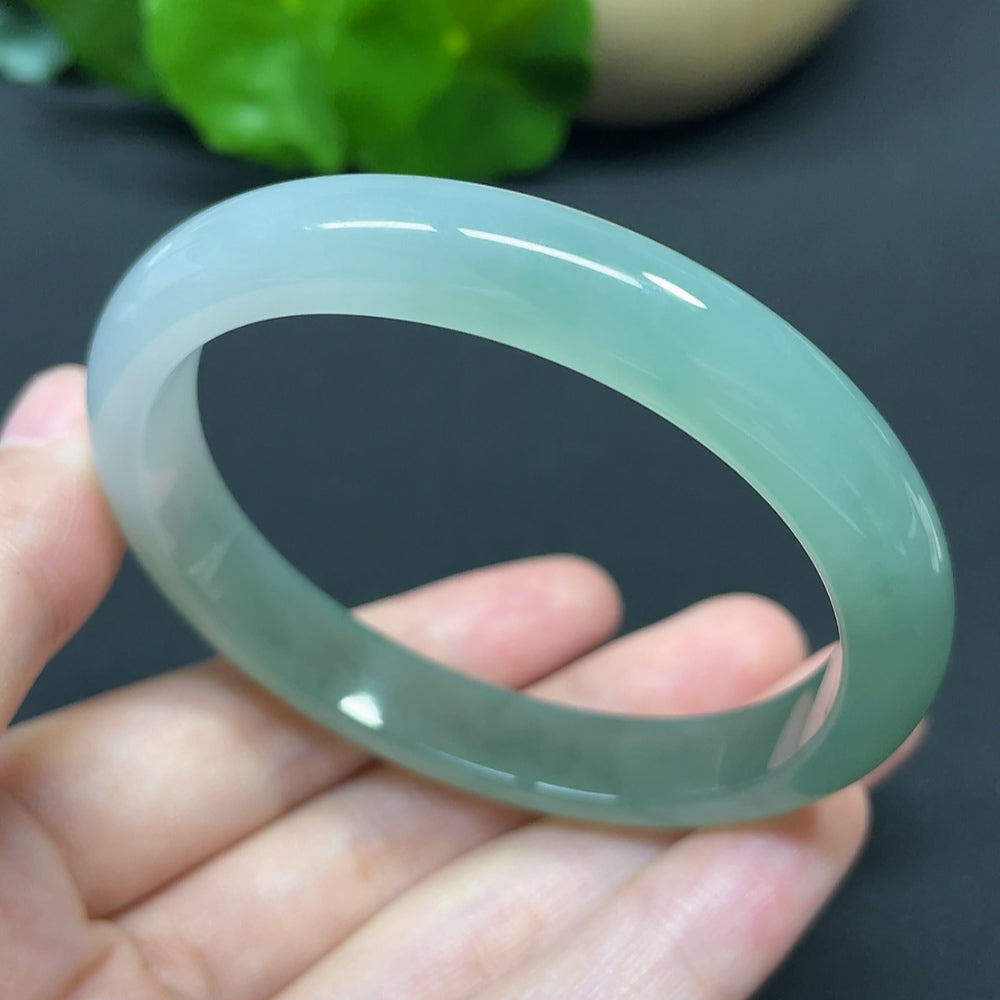 HKHQ jadeite oval bangle in size 55.6 with a weight of 35.37g, showcasing smooth, polished jadeite bracelet detail.