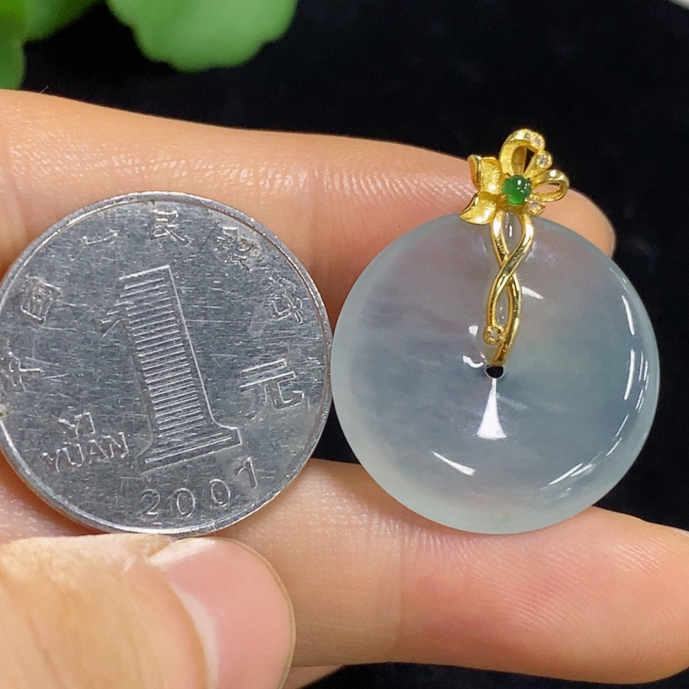 Jadeite Peace Knot pendant with 18K gold setting, crafted by HUILIU HQ, featuring a smooth green jade surface and intricate design.