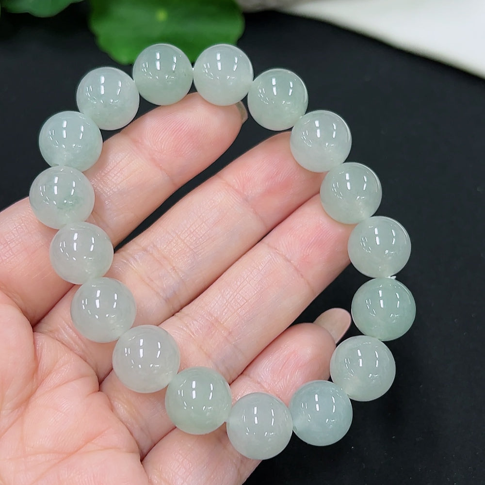 HKHQ jadeite bracelet with 11.2mm beads, approximately 41.89g, showing smooth, polished green jade stones on a white background.