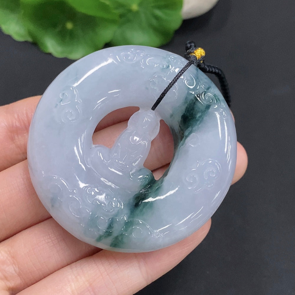 Huiliu Jadeite Enlightenment Pendant featuring smooth, polished green jade with carved details, hanging from a silk cord.