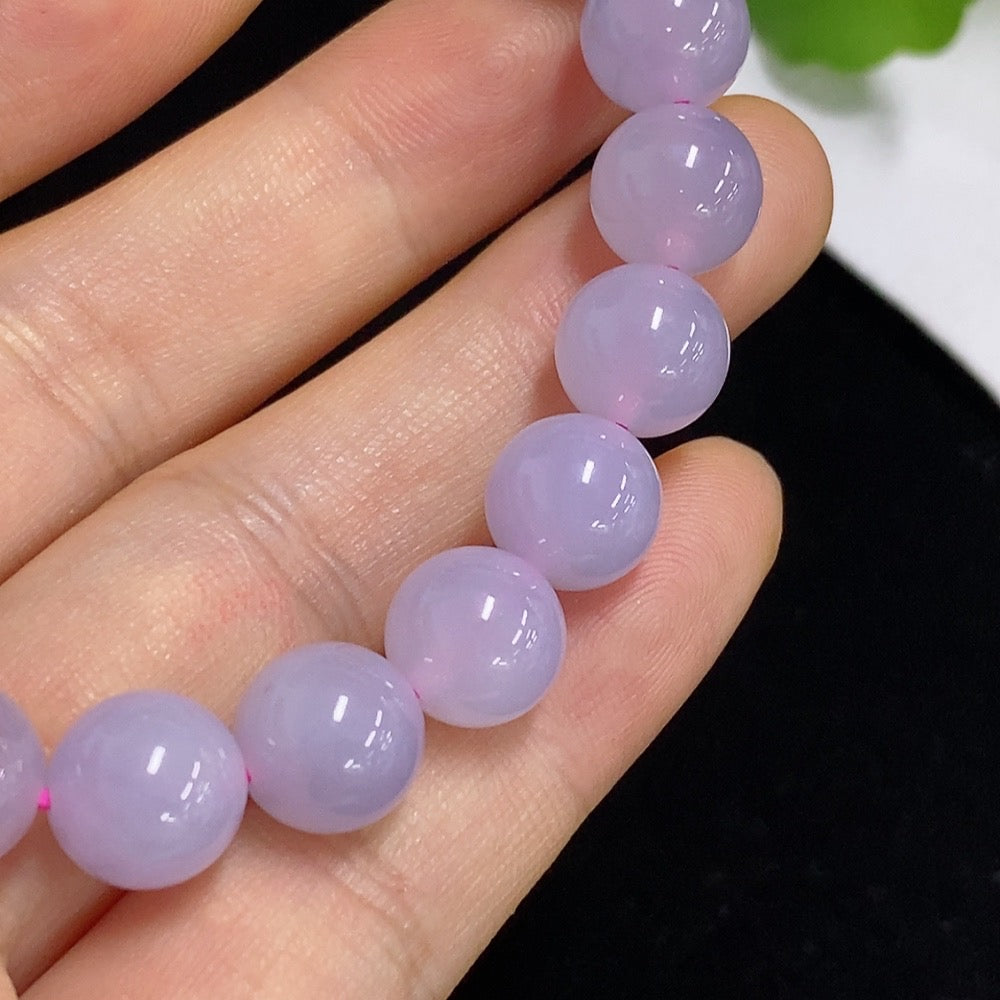 Jadeite bracelet with 9.8mm jade beads from HKHQ, non-gold, weighing approximately 30.64g, shown on a neutral background.