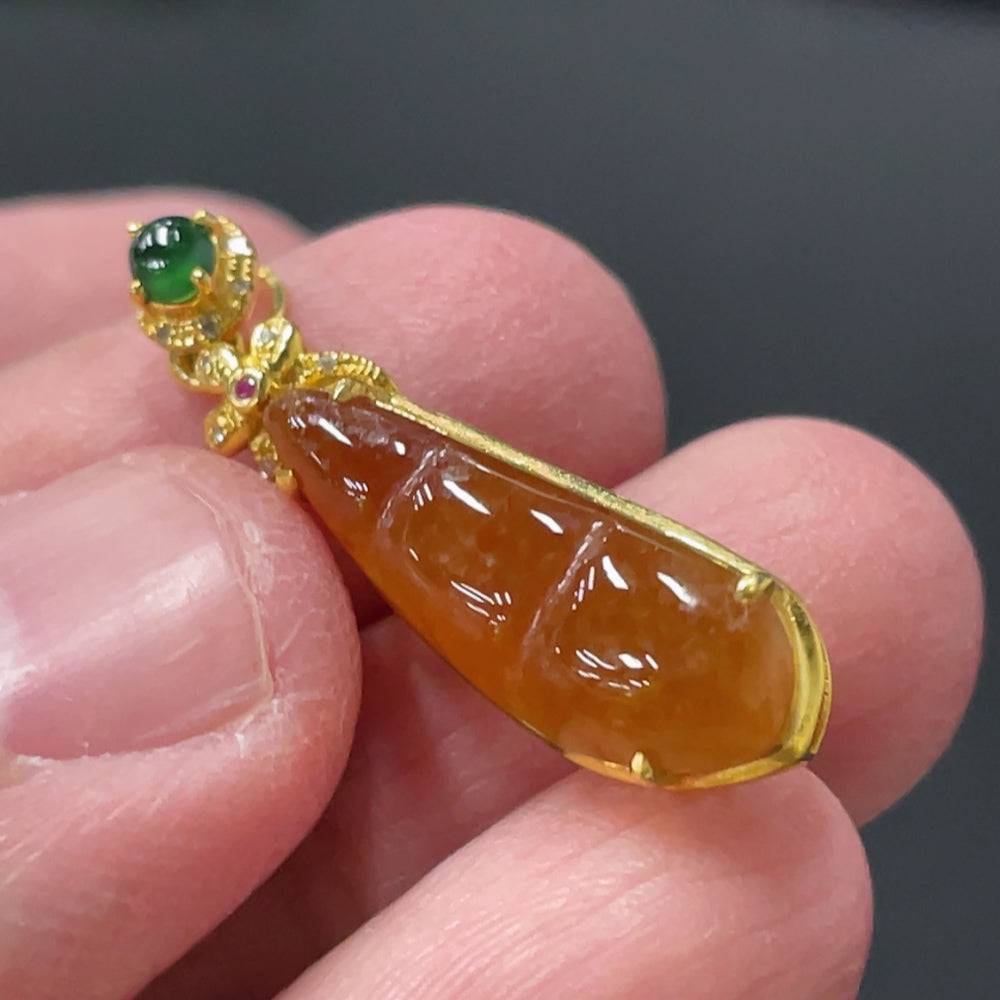 Jadeite auspicious bean pendant with 18K gold and diamond inlay, showcasing a smooth jade surface and intricate craftsmanship.