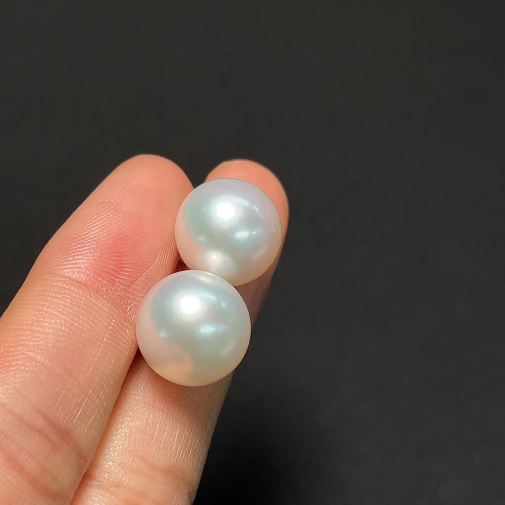 Saltwater pearl earrings with 18K gold hoops by HKHQ, showcasing lustrous pearls and elegant gold detailing.