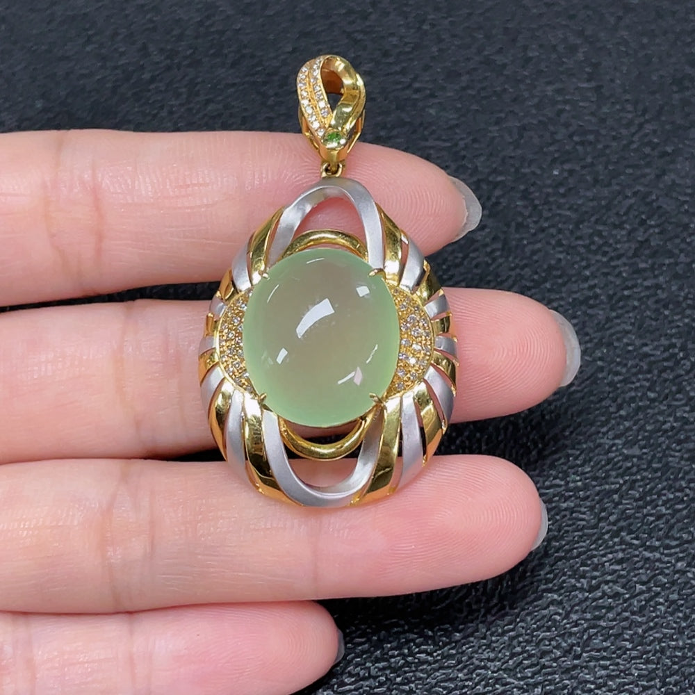 Prehnite pendant with diamond accents on an 18K gold chain, featuring a polished gemstone and elegant jewelry design.