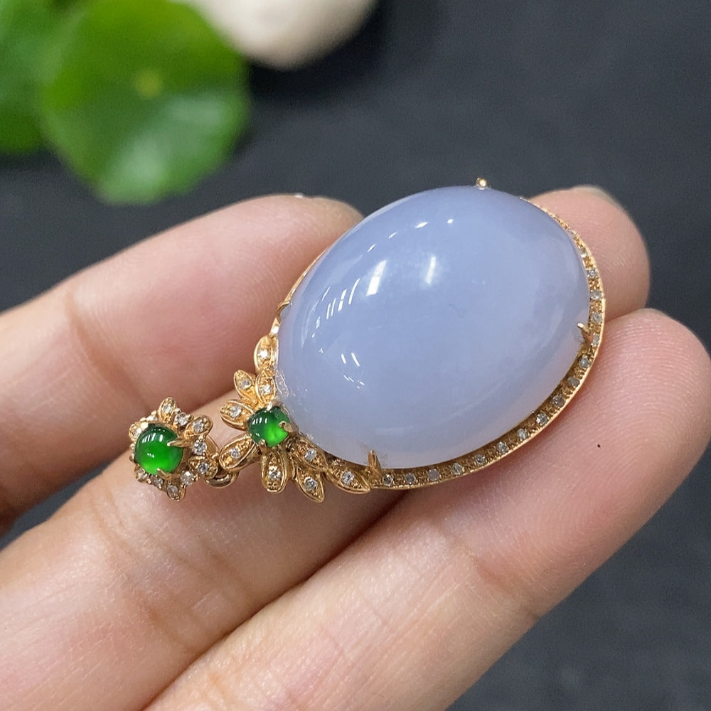 Jadeite bezel-set cabochon pendant with 18k gold and diamond accents, showcasing a polished green jade stone and intricate design.