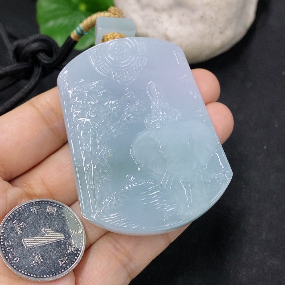 Jadeite pendant featuring Samantabhadra figure, carved in vibrant green jadeite, suspended on a necklace chain.