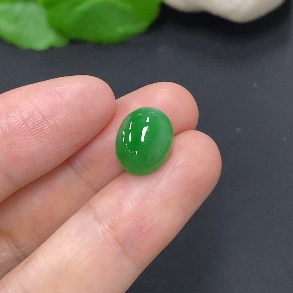 HKHQ jadeite cabochon jewelry piece, approximately 1.1g, showcasing smooth, polished green jadeite gemstone with natural luster.