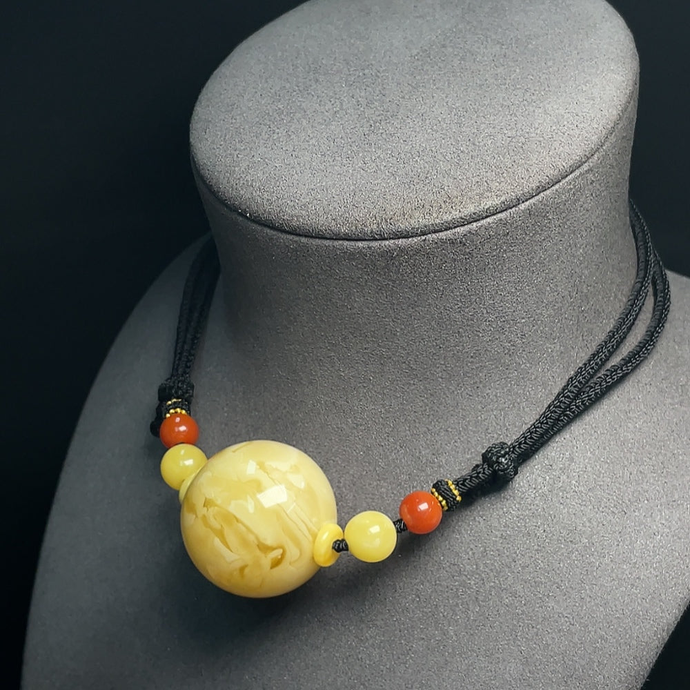 Amber beeswax pendant with Southern Red Agate, 33mm, attached to rope, HUILIU HQ certified jewelry piece.