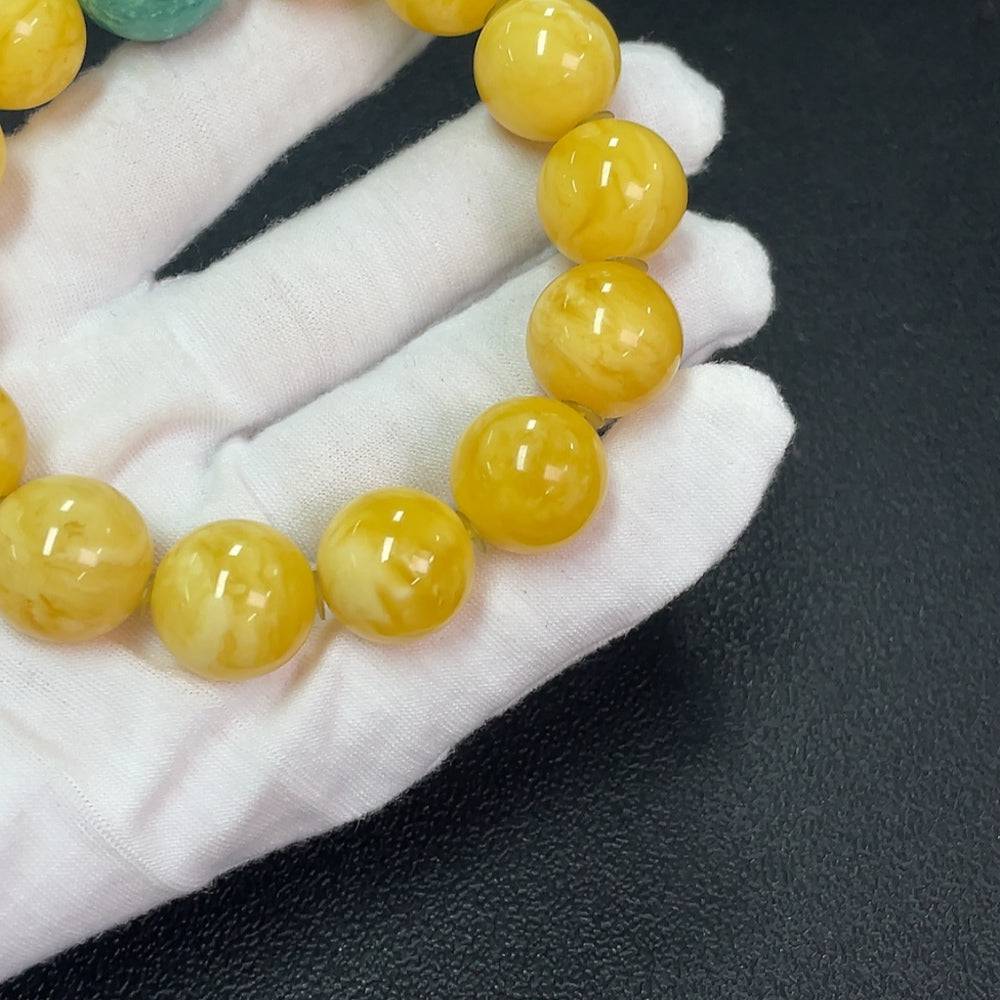 Amber beeswax bracelet with accent stones, 16.2mm size, from HUILIU HQ, showing detailed amber beads and decorative stones.