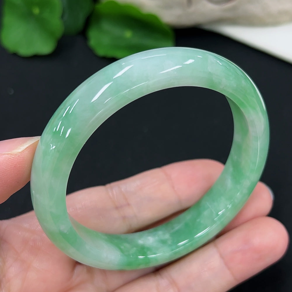 Jadeite round bangle in size 55.1 with approximately 50.4g weight, showcasing smooth, polished jadeite surface and rich green color.