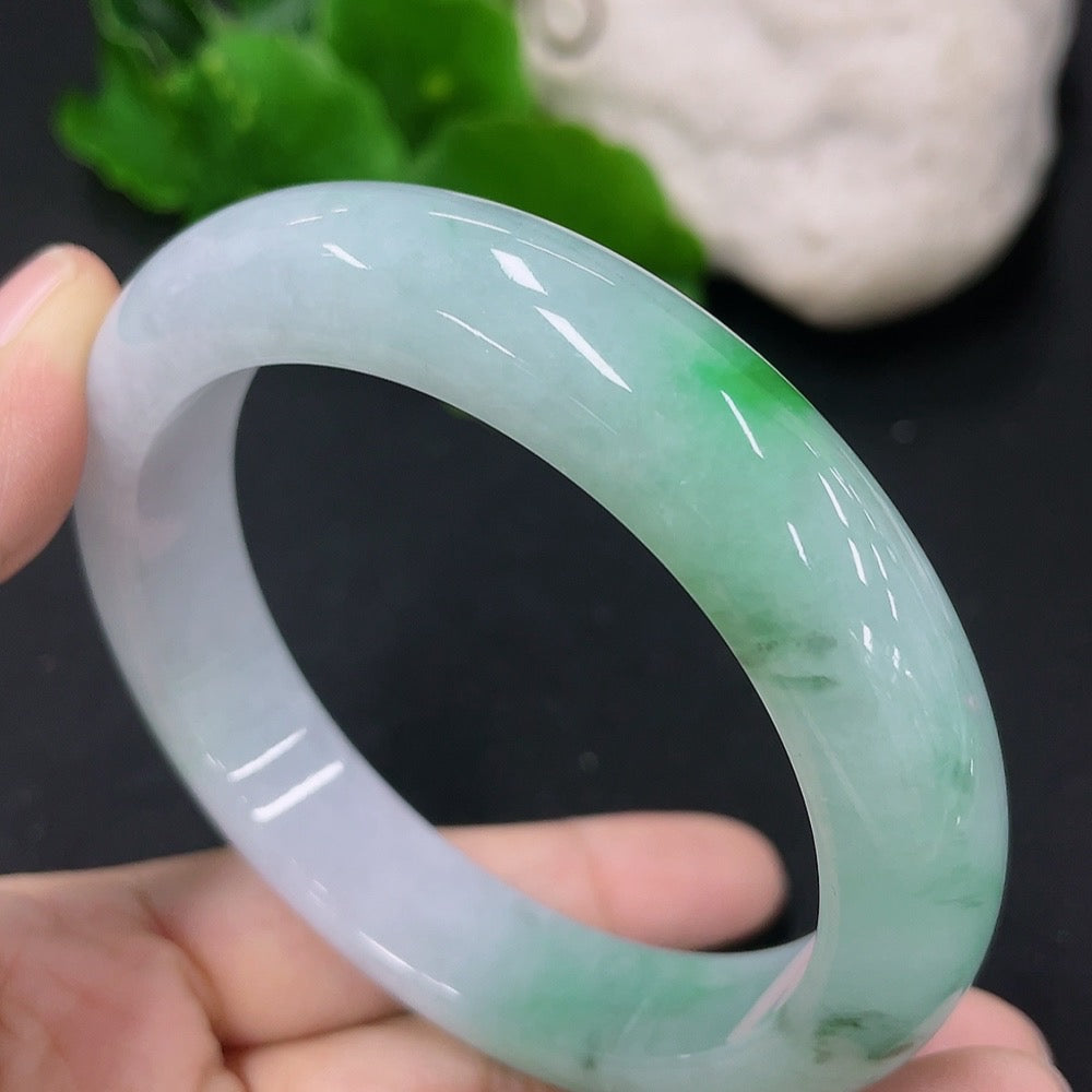 HKHQ jadeite round bangle in size 56, weighing 62.44g, showcasing smooth, polished green jadeite bracelet on a neutral background.