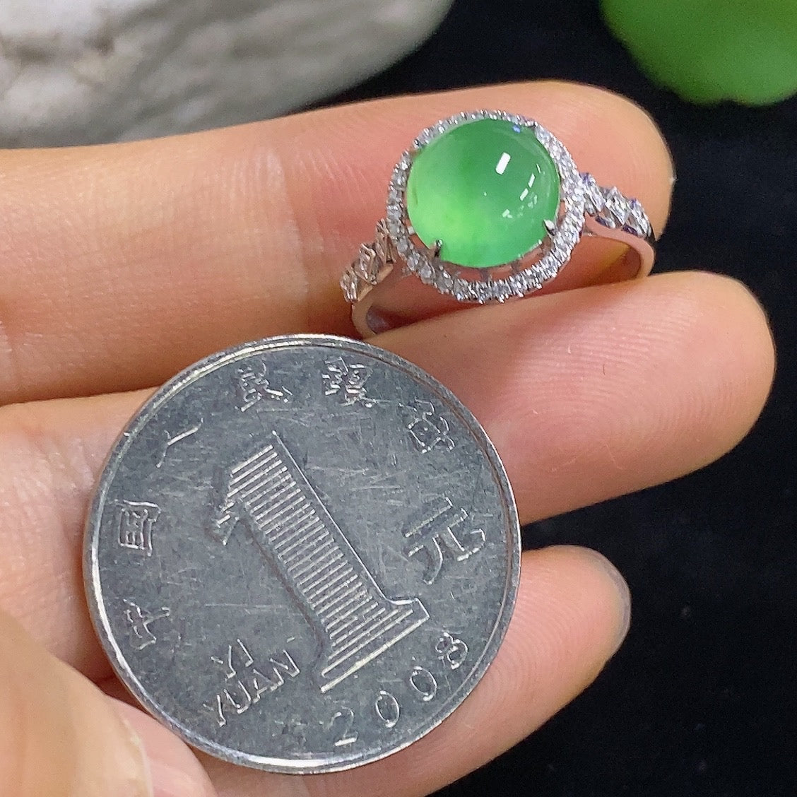 Jadeite cabochon inlaid ring with 18K gold and diamond accents, featuring a polished green jade stone set in a luxurious ring design.
