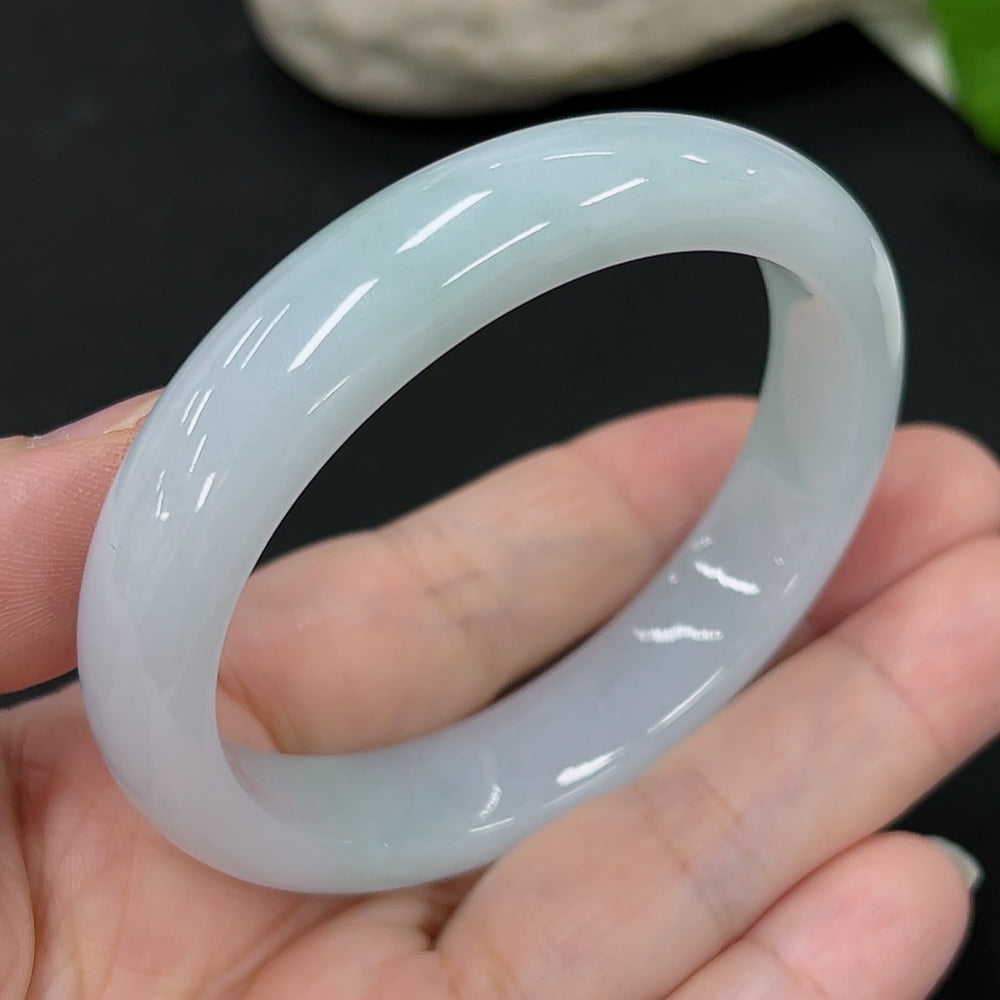 HKHQ jadeite oval bangle in size 54.6 with a weight of 44.9g, showcasing smooth oval shape and vibrant green color.