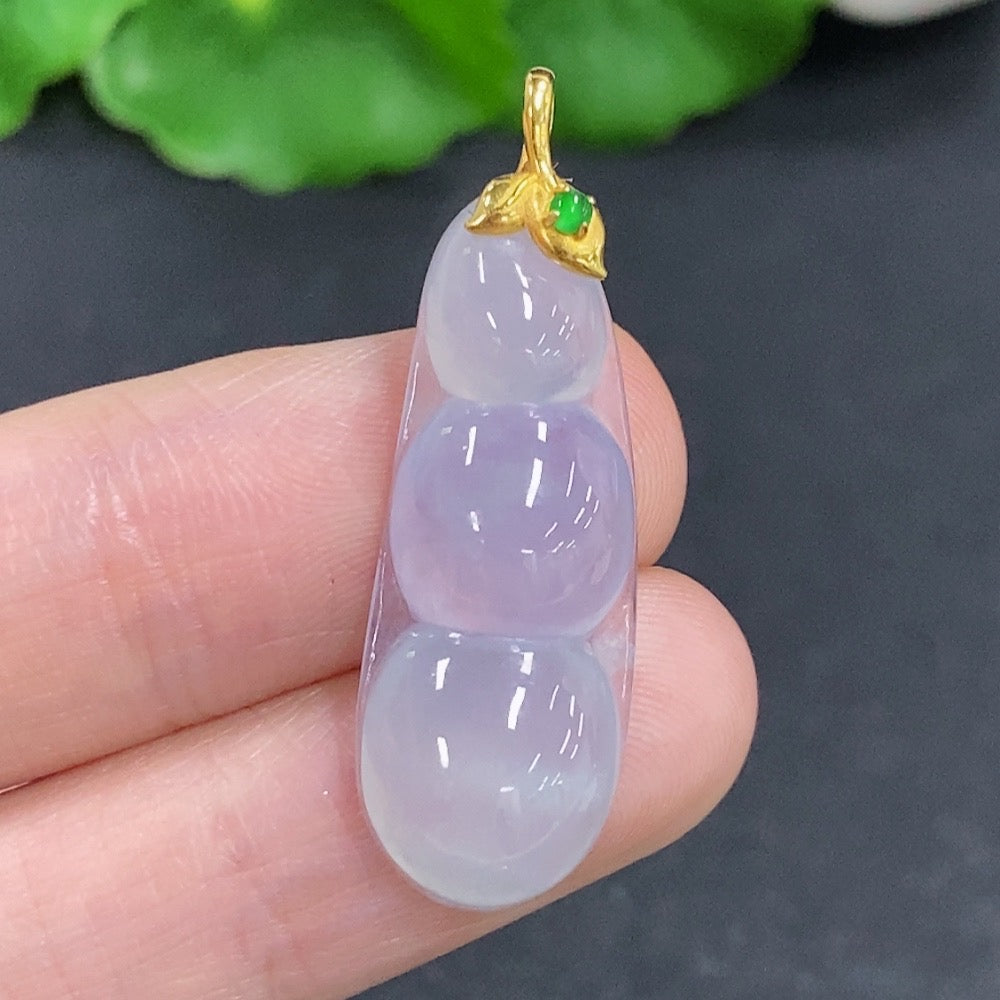 Jadeite lucky bean pendant with 18k gold clasp, smooth green jade with subtle natural markings, weighing approximately 3g.