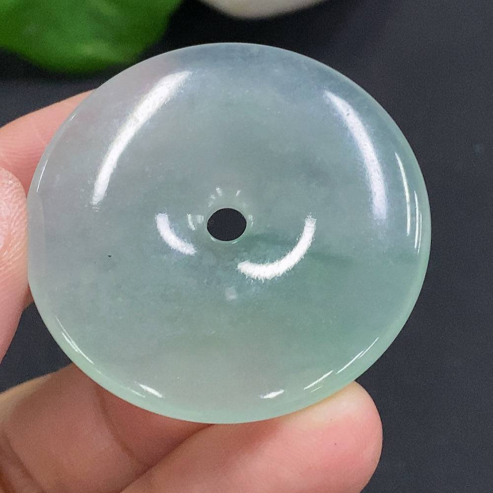 HUILIU HQ jadeite Peace Knot pendant, approximately 17.4 grams, featuring a polished jade jadeite design on a natural stone surface.