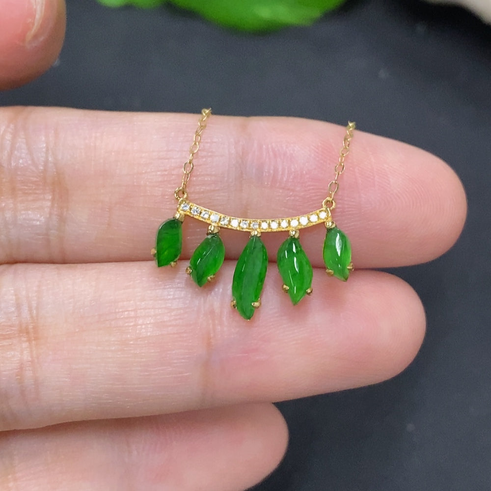Jadeite inlaid pendant with 18K gold and diamond accents, featuring a polished jade stone and delicate gold detailing.
