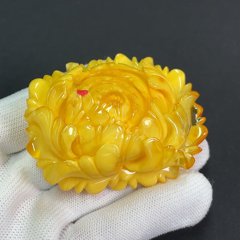 Amber beeswax pendant with visible repairs, crafted by HKHQ, weighing approximately 36.25 grams, showcasing natural amber texture and craftsmanship.