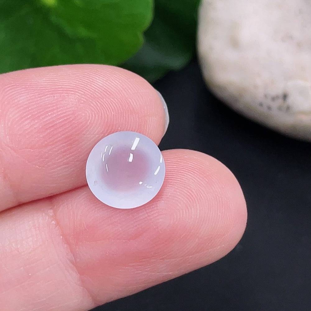 Jadeite cabochon from HUILIU HQ, approximately 0.6g, showcasing smooth, polished green jade with natural translucency.