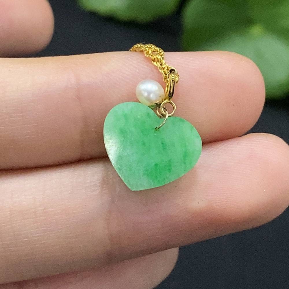 Jadeite heart pendant necklace in 18K gold with chain, weighing approximately 1.63g, featuring a polished jade heart charm.