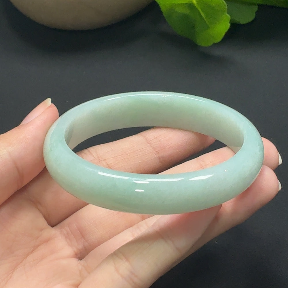 Jadeite round bangle with size 55.8 and weight approx. 45.69g, crafted from smooth, polished jade stone with a glossy finish.