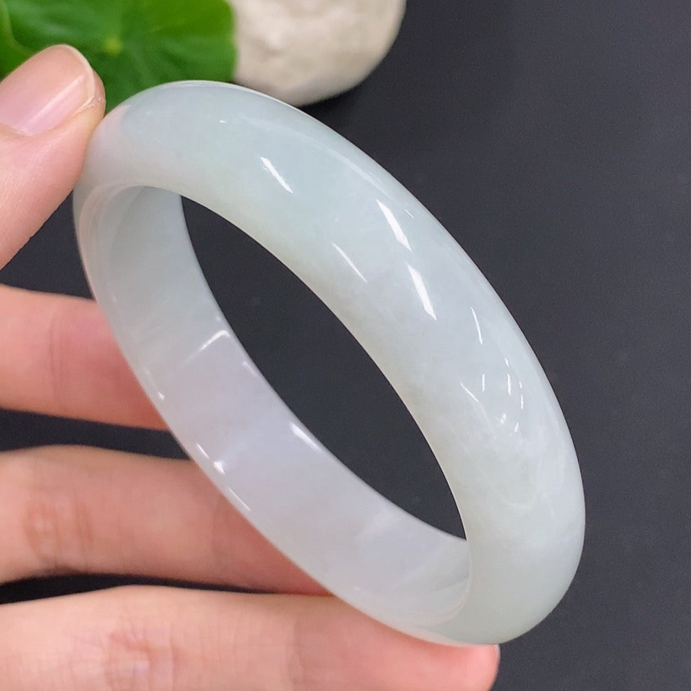 Jadeite round bangle by HKHQ, 52.7g, size 55.7, featuring a smooth, polished jade surface in a circular shape.