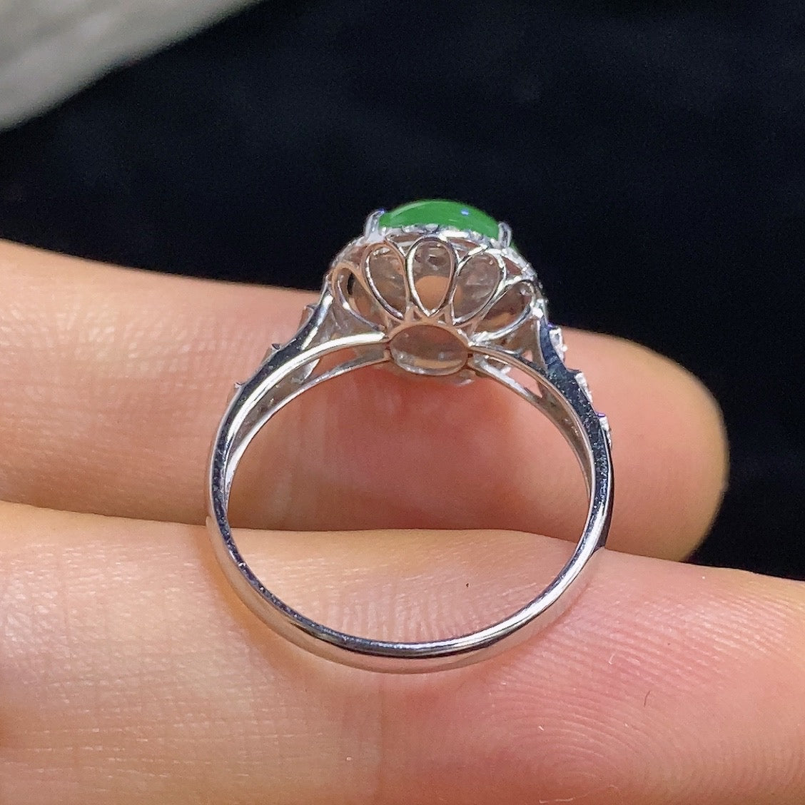 HKHQ jadeite cabochon inlaid ring with 18K gold and diamond accents, showcasing a detailed close-up of the elegant jewelry piece