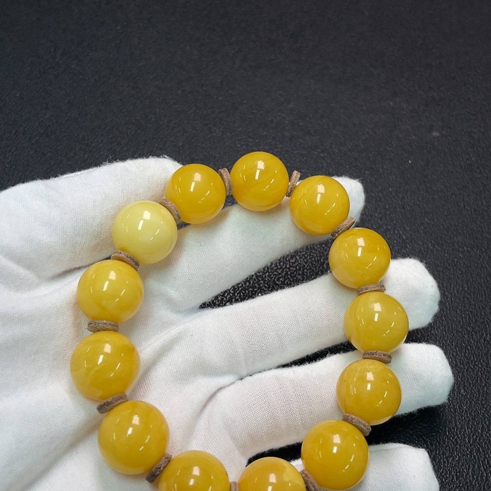 Huiliu Amber Beeswax Bracelet featuring round amber beads, approximately 16.1mm, with a natural warm amber hue.