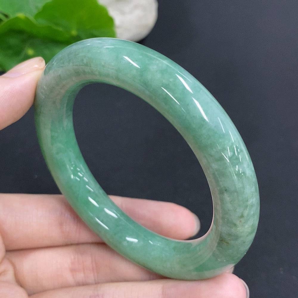 Huiliu Certified Jadeite round bangle with smooth polished surface, showcasing vibrant green jade color and elegant craftsmanship.