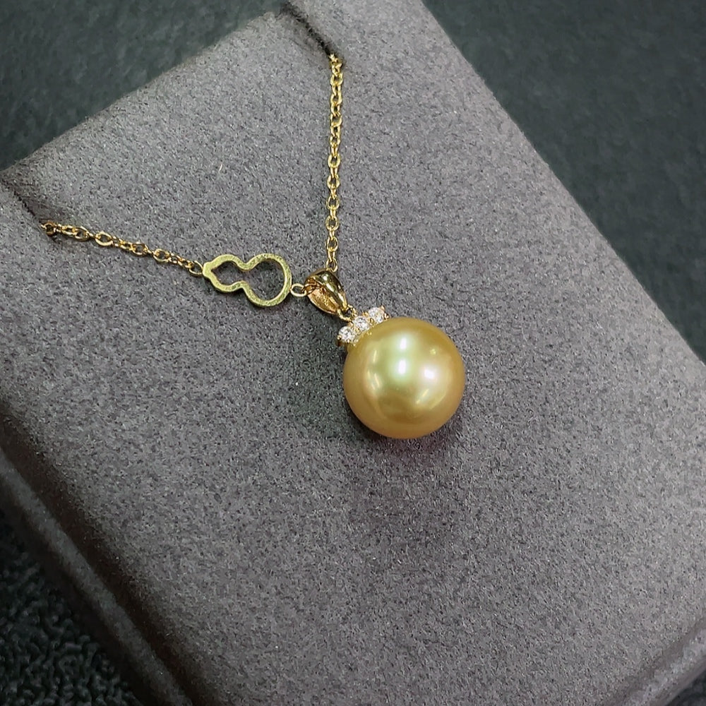 Seawater pearl pendant in 18K gold with non-gold chain, showing the 10.5mm pearl and gold setting on a plain background.