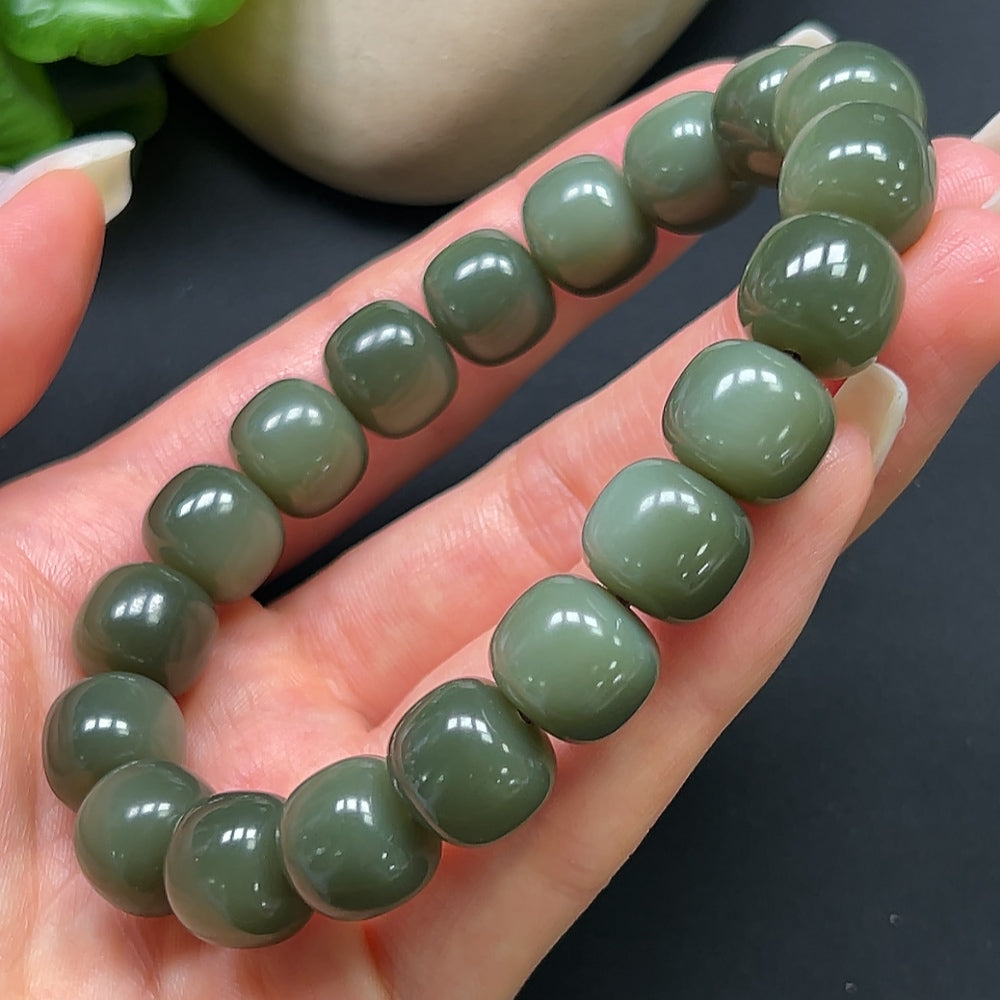HKHQ Hetian Jade bracelet with 12mm round beads, showcasing smooth, polished green jade stones on a delicate bracelet.