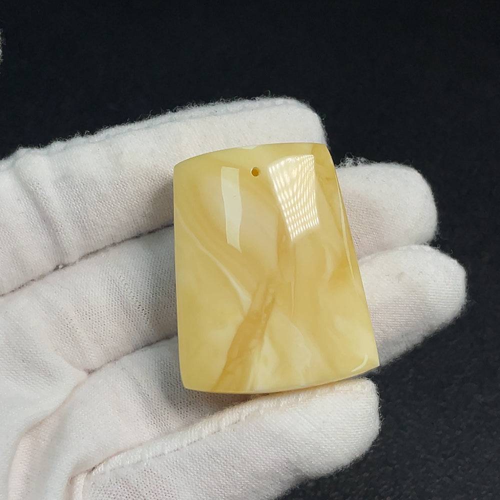 Amber beeswax pendant with natural amber coloration, weighing approximately 10.42 grams, crafted by HUILIU HQ.