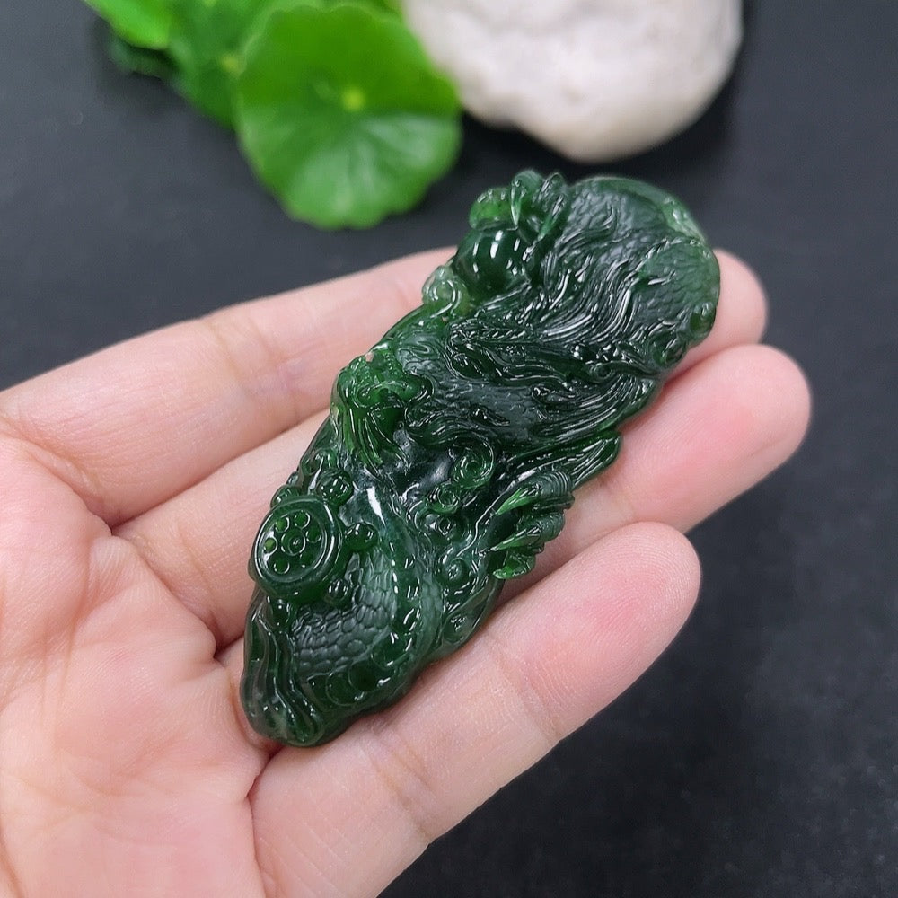 Jadeite pendant featuring a carved dragon plaque, weighing approximately 21.95g, crafted by HKHQ with intricate jade detail.