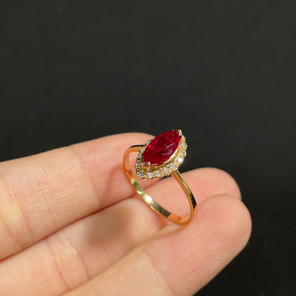 18K gold ruby ring with diamond accents, elegant jewelry piece featuring a vibrant ruby gemstone and sparkling diamond details.