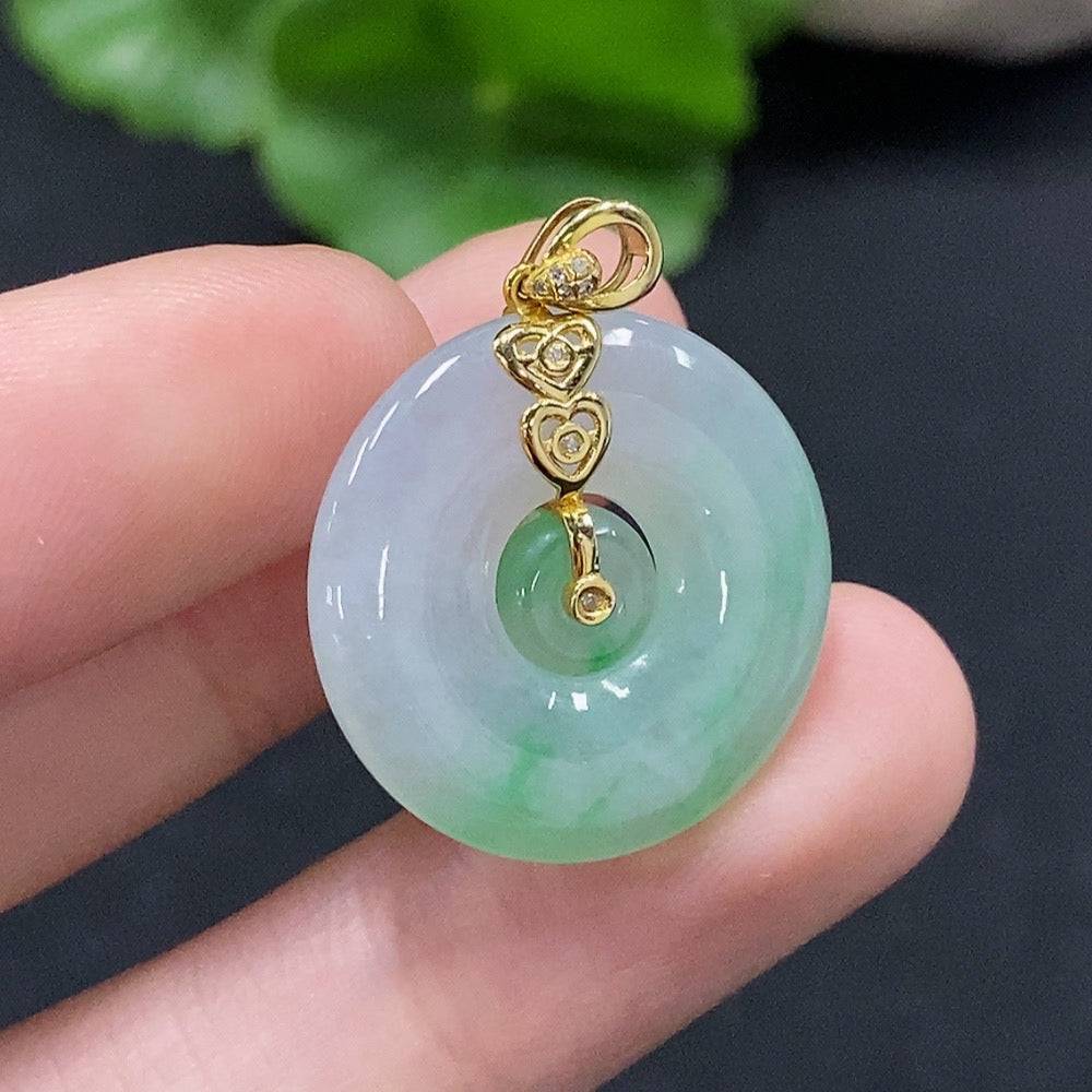 Jadeite mother-and-son pendant with 18K gold and diamond accents, featuring intricate inlay work and a polished jade surface.