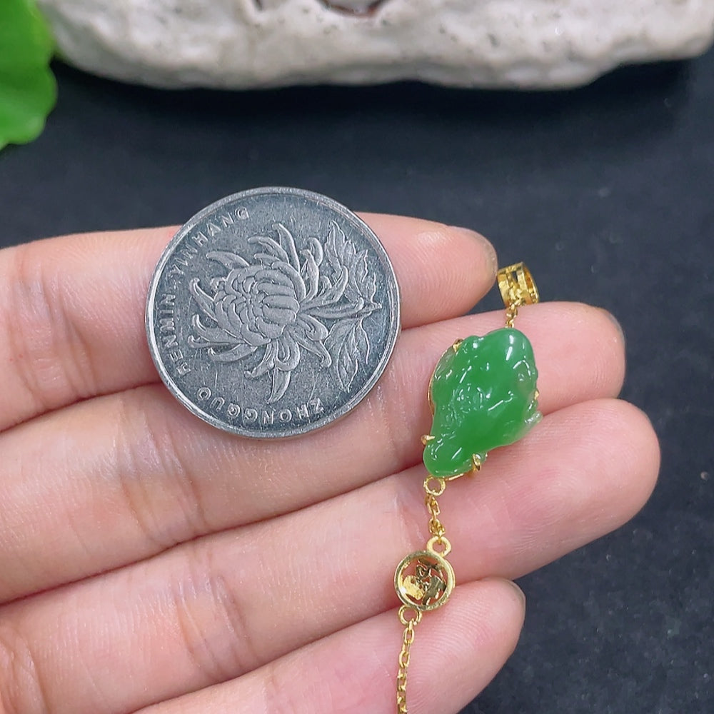 Elegant jadeite bracelet with 18K gold and diamond accents, showcasing smooth green jade and sparkling detailing.