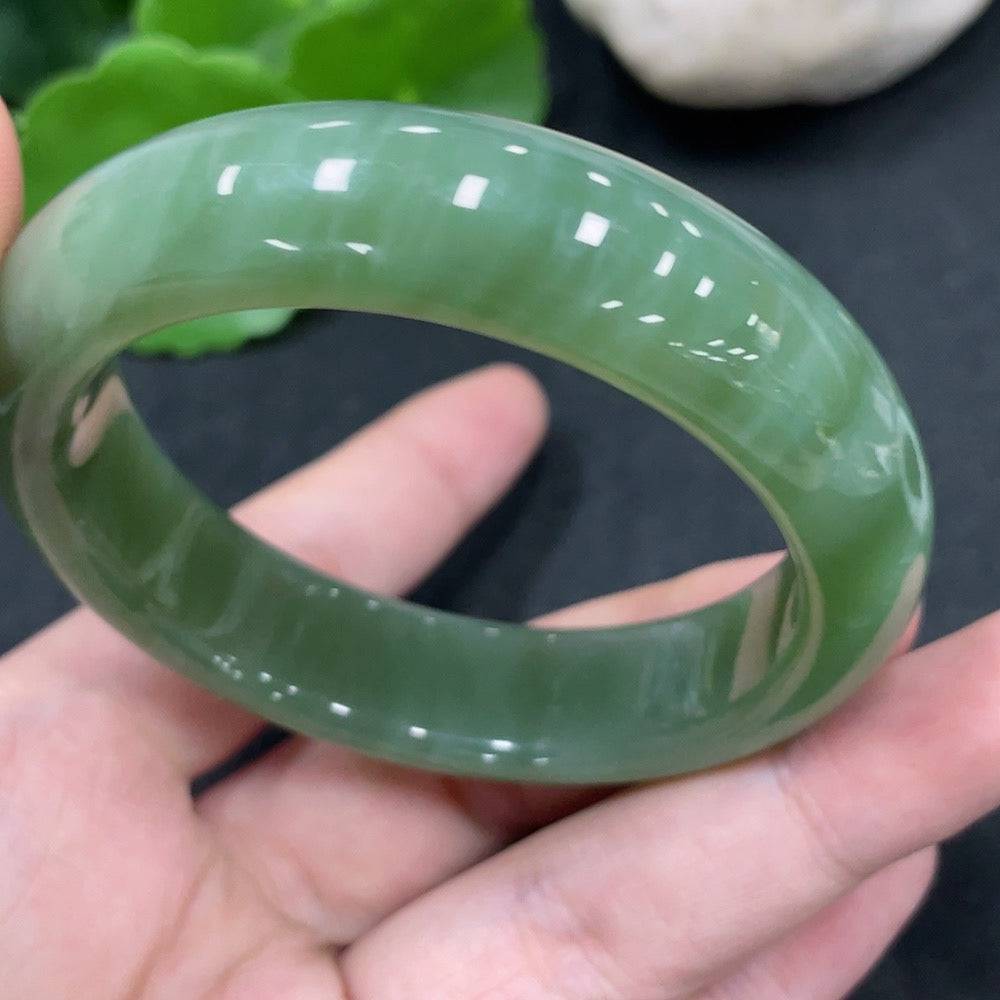 Huiliu certified Hetian jade round bracelet with smooth, polished jade beads, showcasing elegant craftsmanship and natural green tones.