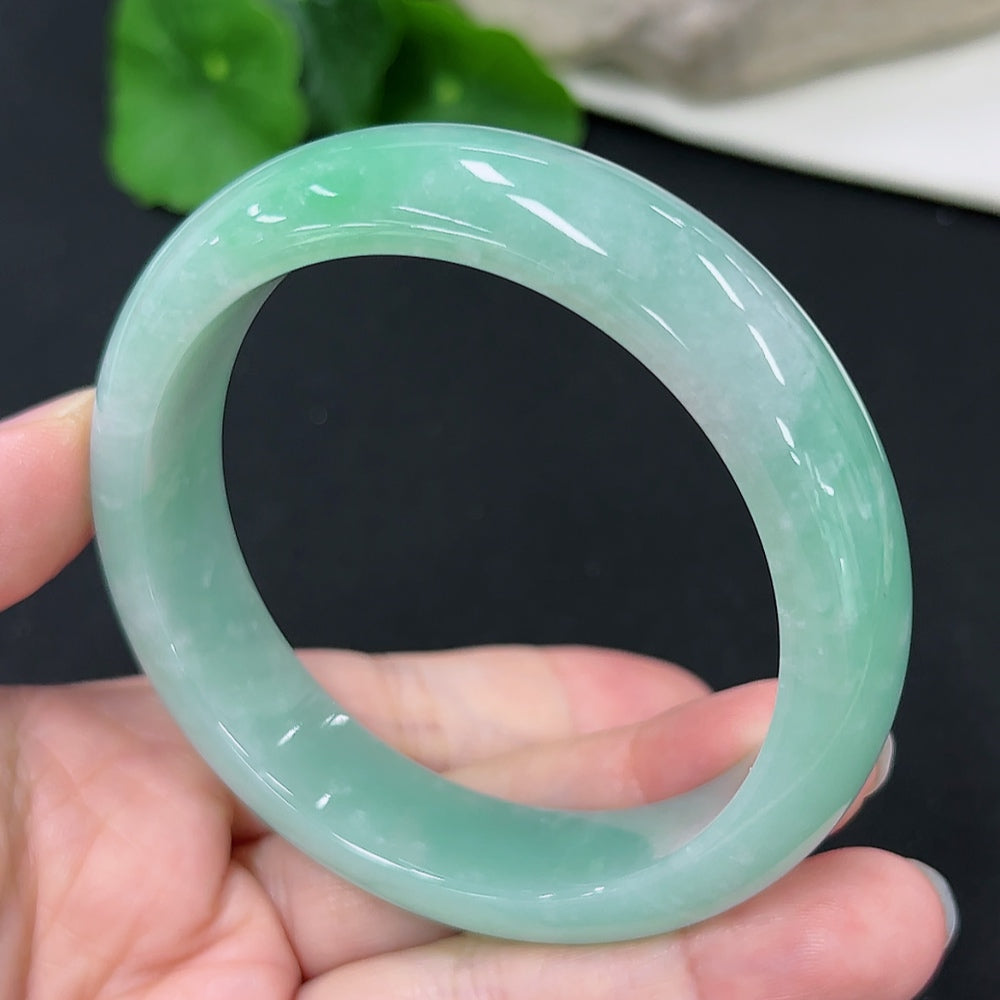 HKHQ jadeite round bangle in size 57.7 with a total weight of 66g, showcasing smooth, polished jadeite surface.