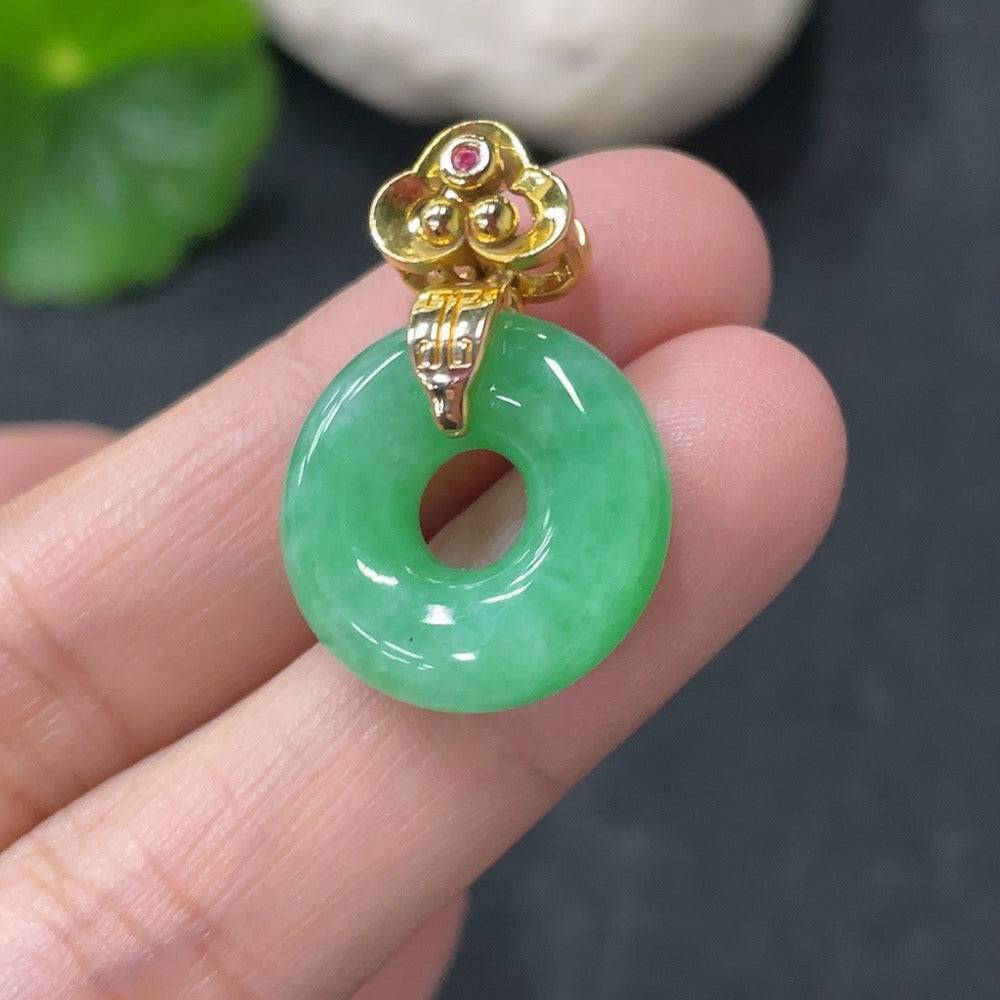 Huiliu Jadeite pendant in donut shape with suspected plating, featuring a smooth, polished jade surface and natural green hue.