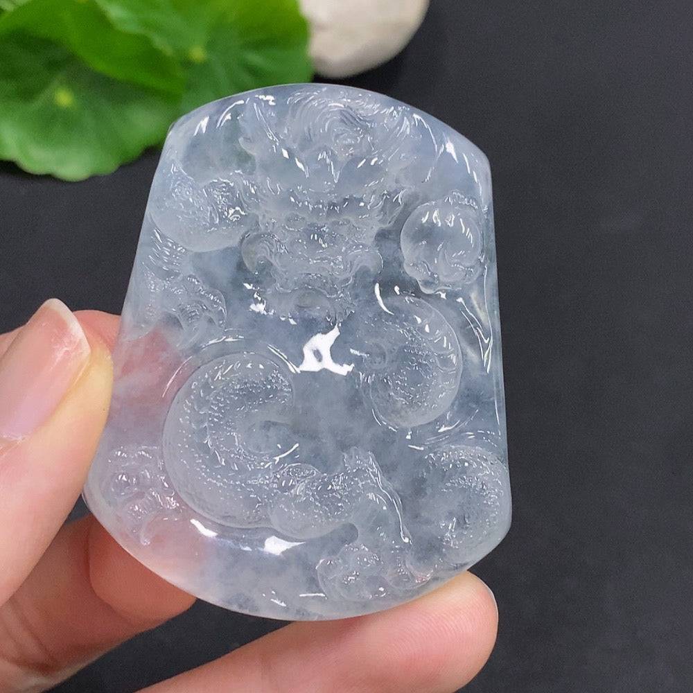Jadeite dragon pendant from HUILIU HQ featuring a detailed dragon soaring across the world in vibrant green jade.