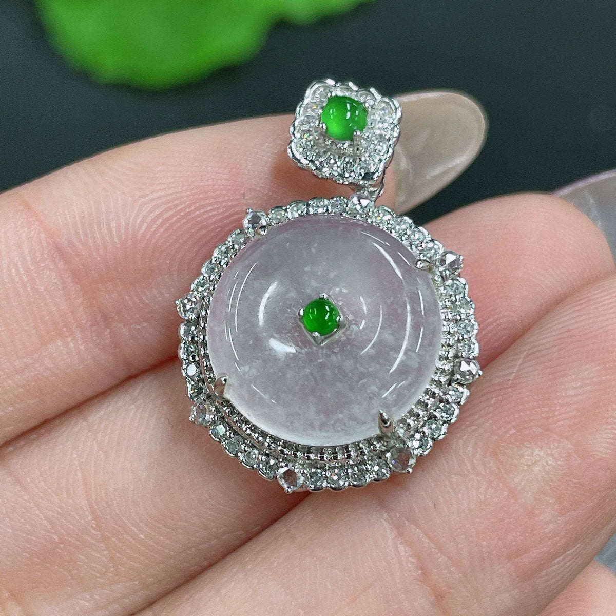 Jadeite Peace Knot pendant with 18k gold and diamond accents, showcasing intricate inlay design and fine craftsmanship.