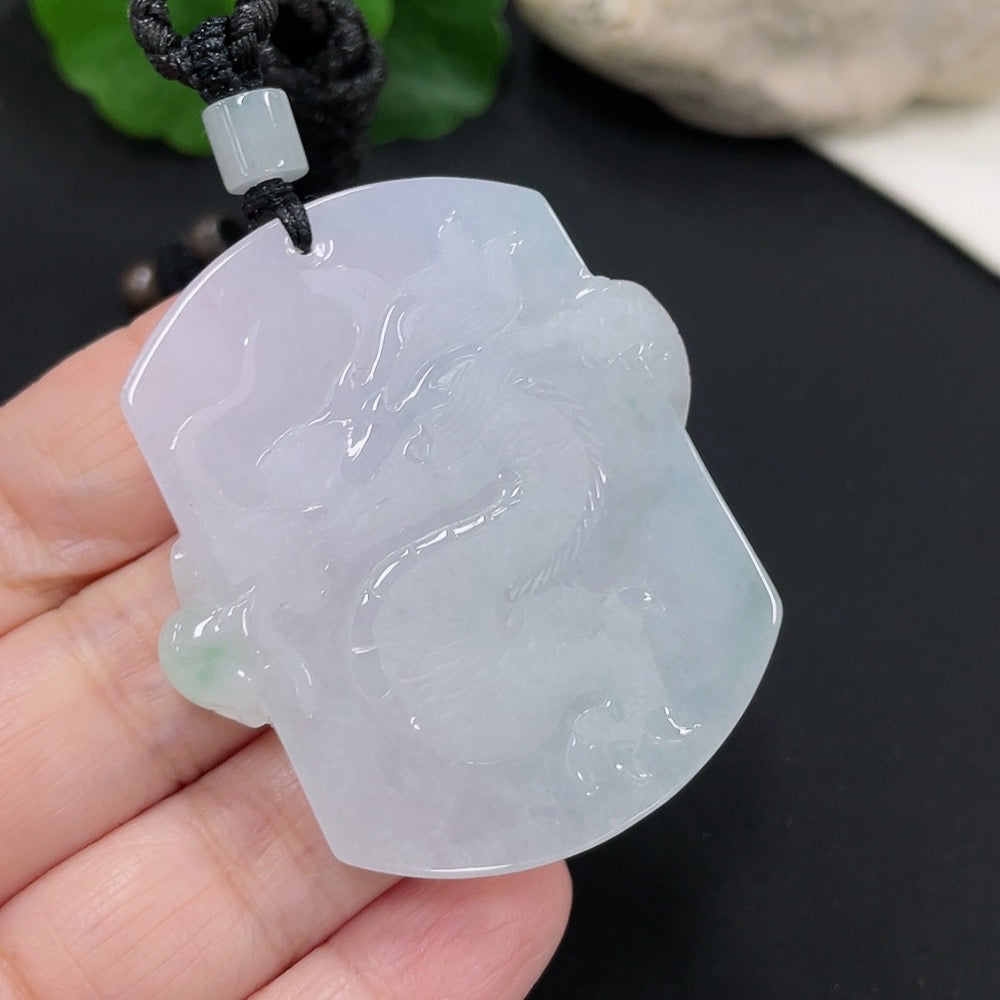 Jadeite dragon pendant from HUILIU HQ featuring a detailed carved dragon design, weighing approximately 34.52 grams with rope.
