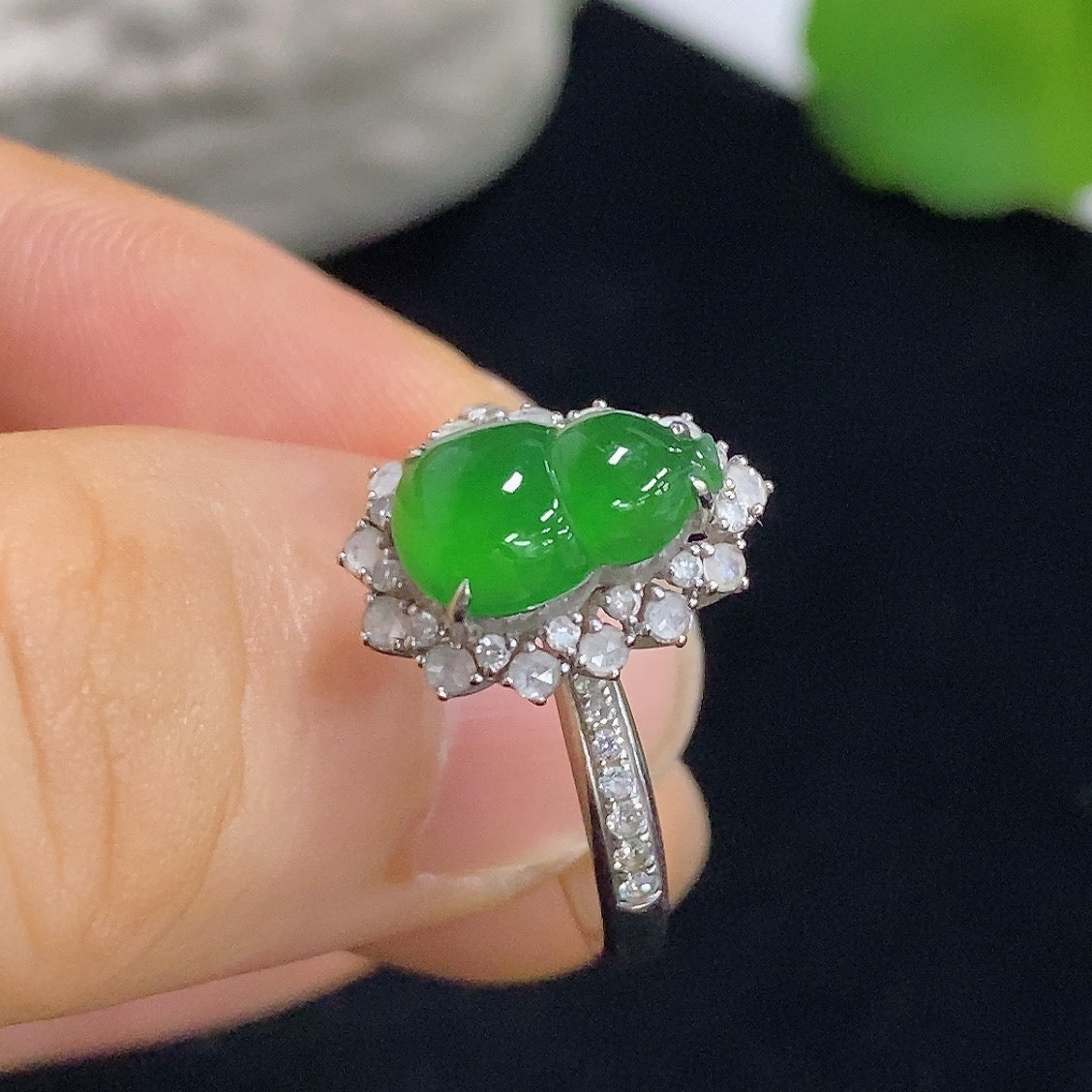 Jadeite gourd inlay ring with 18K gold and diamond accents, showcasing intricate design and craftsmanship.