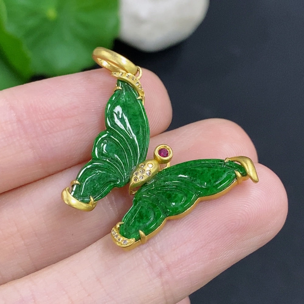 Jadeite pendant with 18k gold mount and diamond accents, featuring mineral inclusions, displayed on a necklace chain.