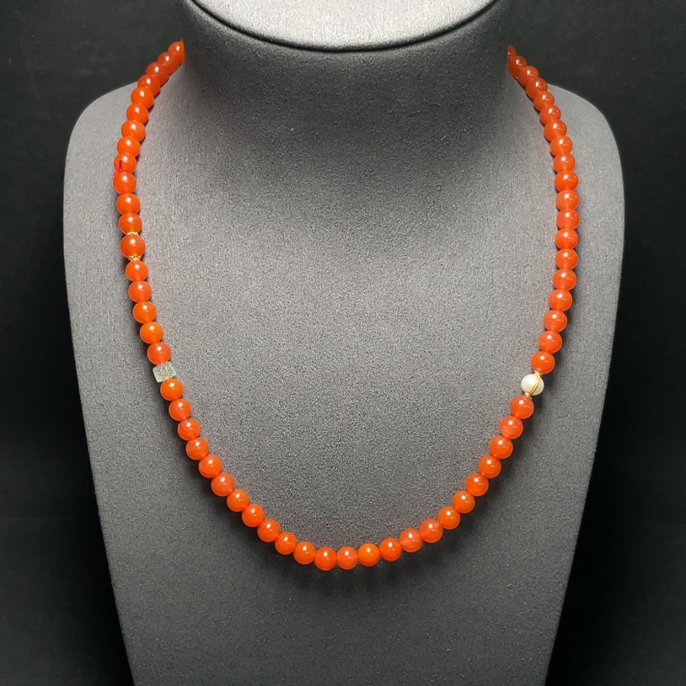 Red agate bead necklace with 18K gold accents, featuring tourmaline and pearl details on a delicate strand.