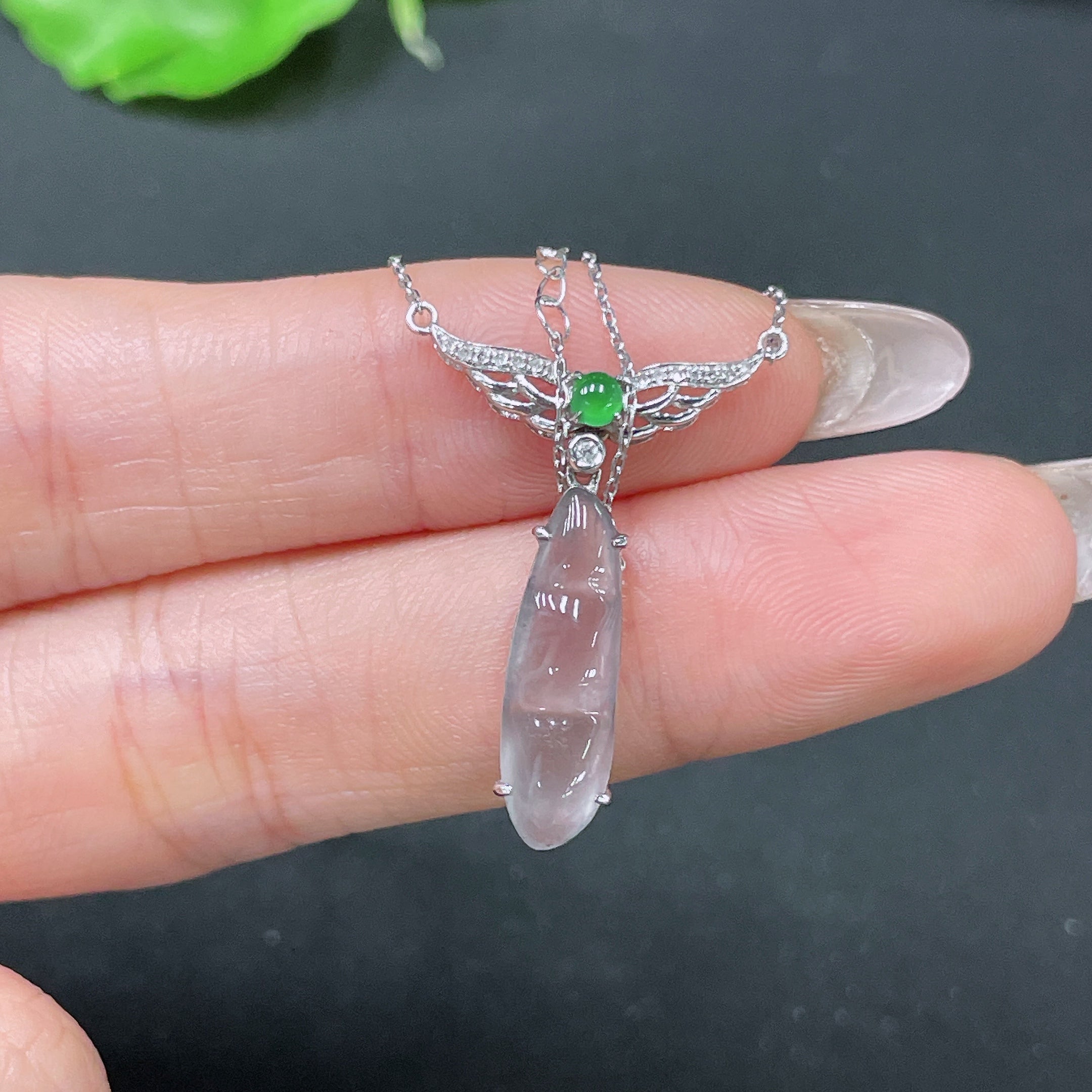 Jadeite bean pendant set in 18k gold with diamond accents, featuring a jade jewelry piece and chain, by HUILIU HQ.
