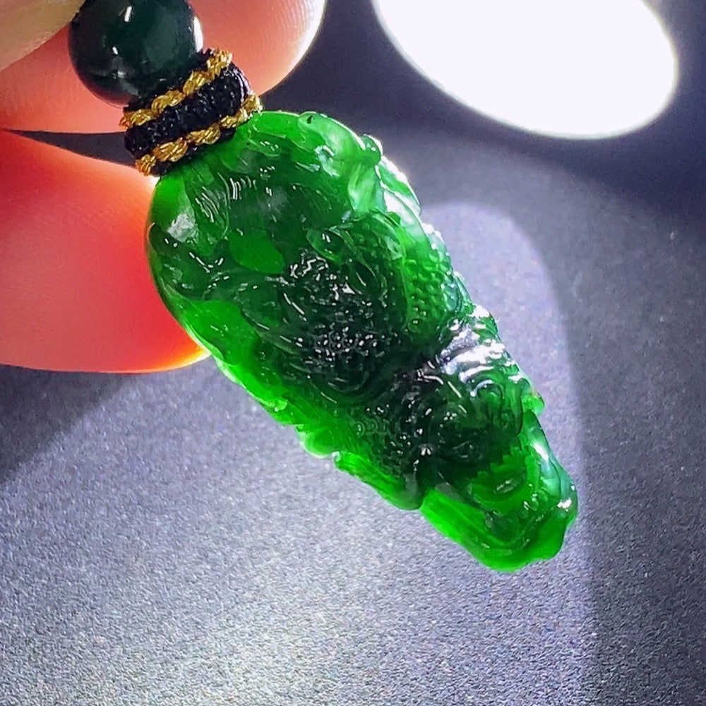 Huiliu Jadeite pendant featuring a carved dragon plaque with rope, crafted from polished jade for elegant jewelry.