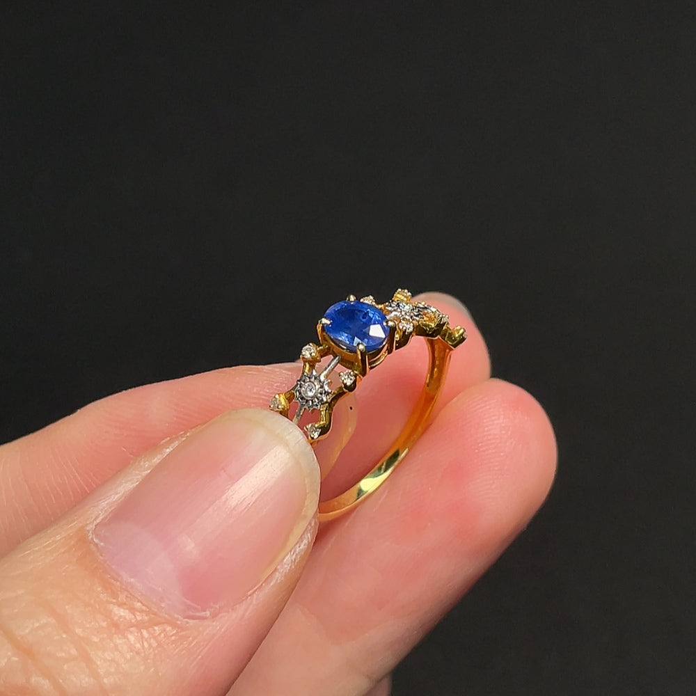 18K blue sapphire ring with diamond accents from HKHQ, featuring a central blue sapphire gemstone and sparkling diamond details.